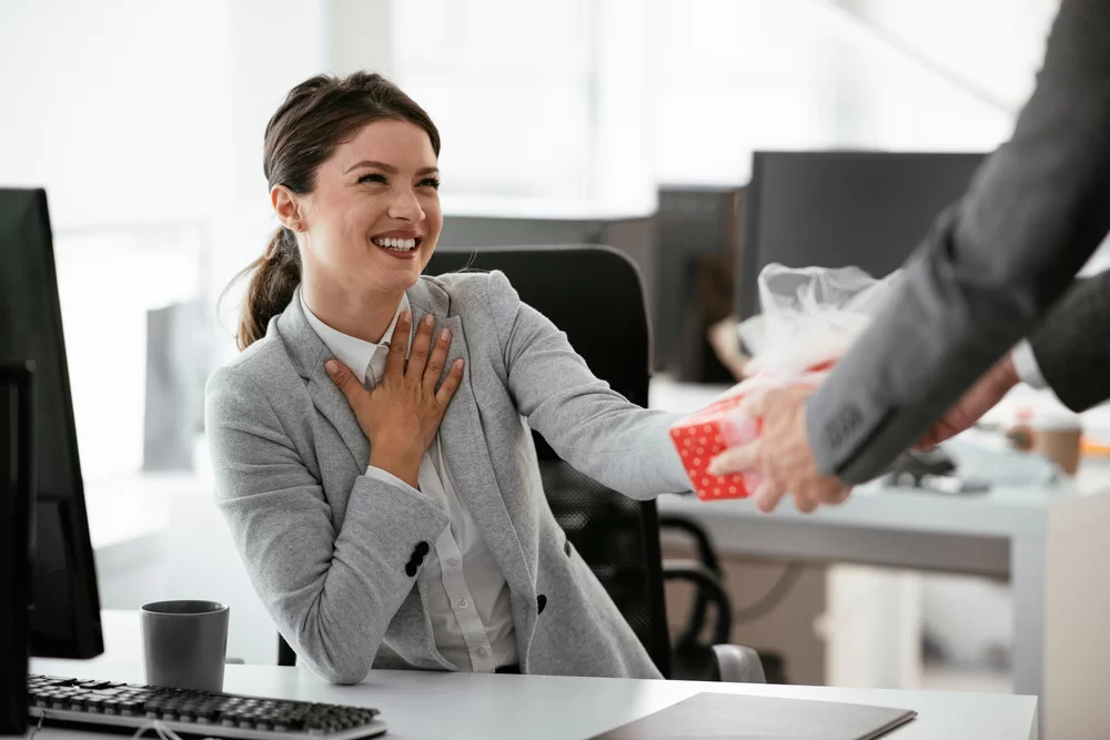 Woman receiving a gift for her work anniversary