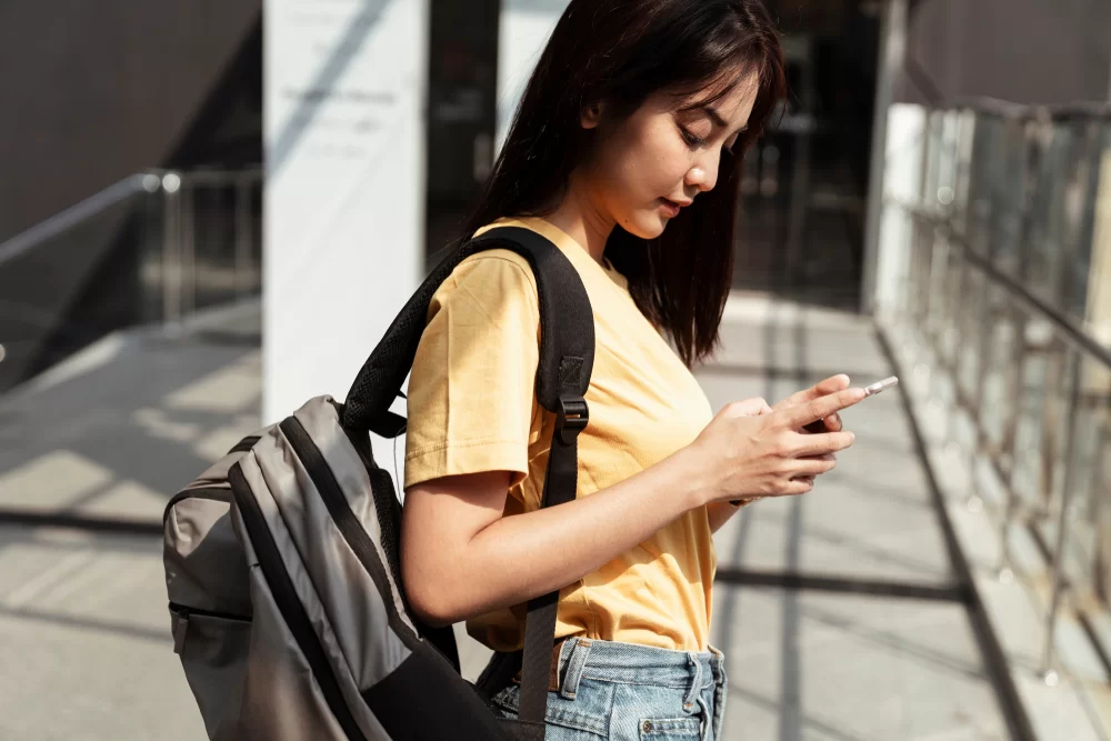 Young woman responding to a "TFTI" text message