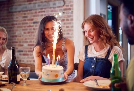 Group of friends celebrating their female friend's birthday
