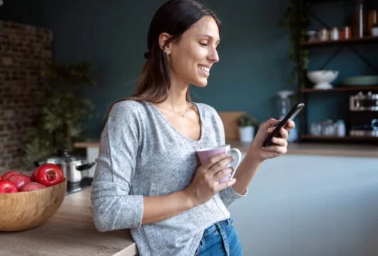 Woman reading a flirty "Have a good day" text message