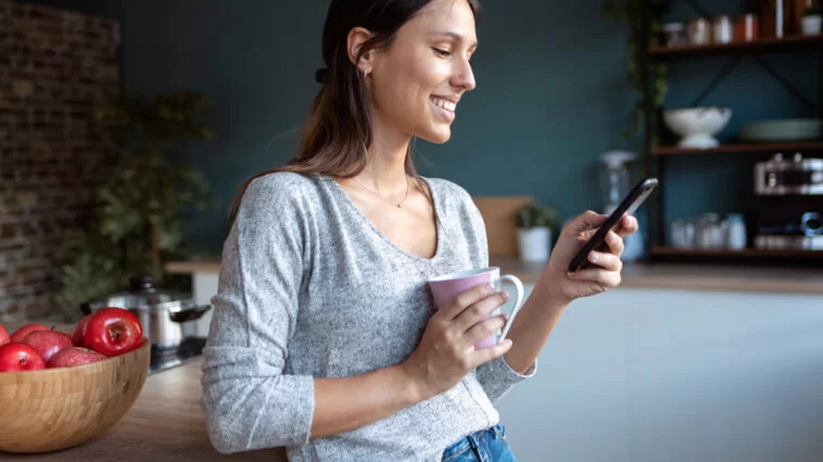 Woman reading a flirty "Have a good day" text message