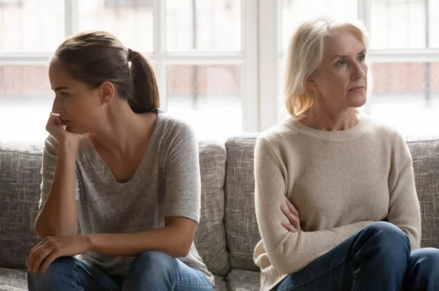 A woman and her estranged daughter sitting next to each other quarreling