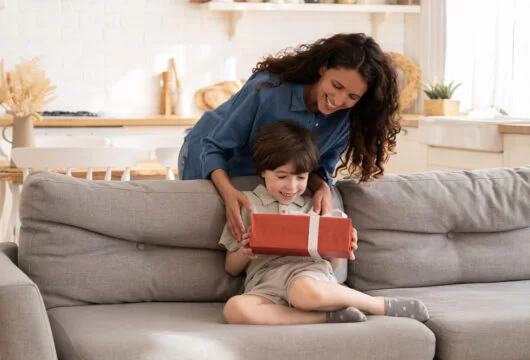 Woman giving a birthday gift to her nephew