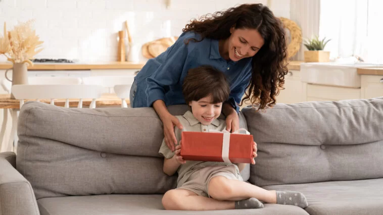 Woman giving a birthday gift to her nephew
