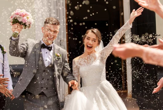 Newly married couple leaving their wedding ceremony
