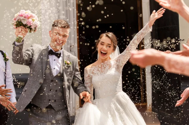 Newly married couple leaving their wedding ceremony