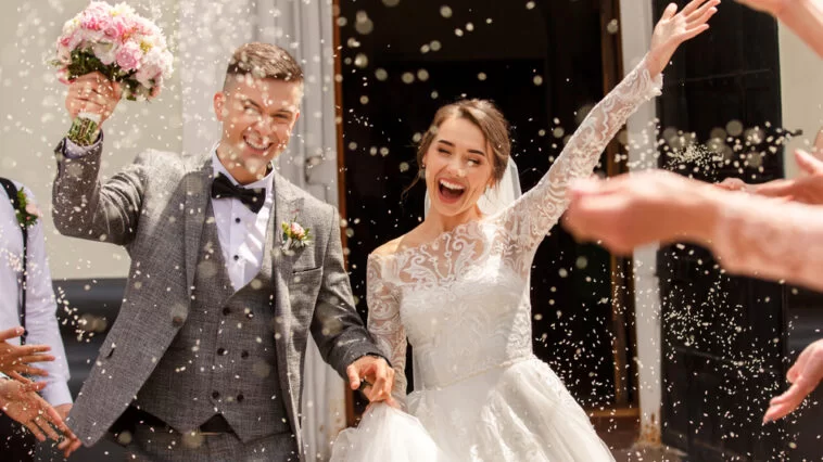 Newly married couple leaving their wedding ceremony