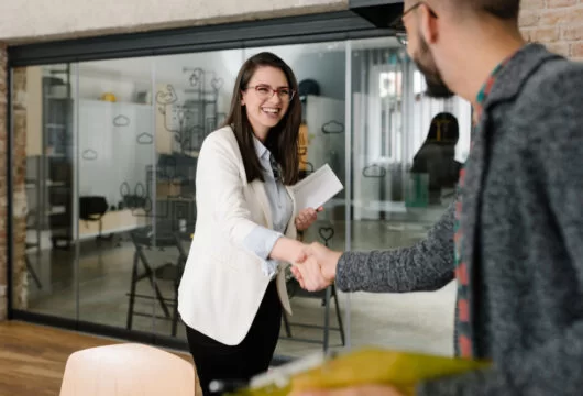 Woman and man shaking hands in the office