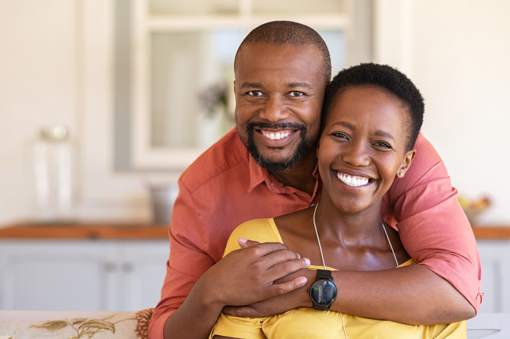 Happy, smiling Black couple embracing