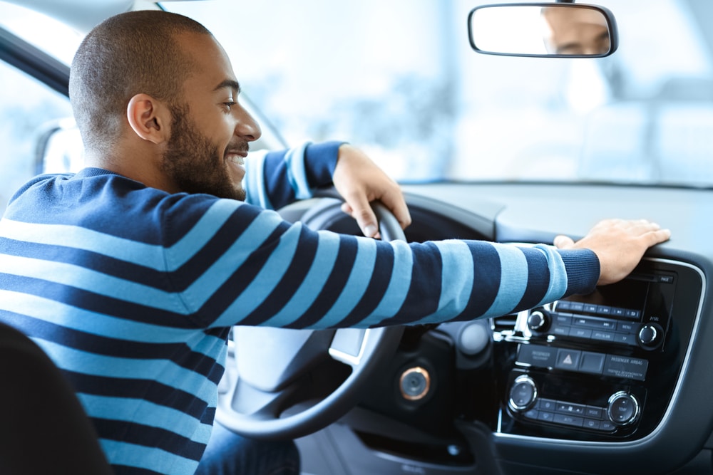 Man sitting behind the wheel of his new car