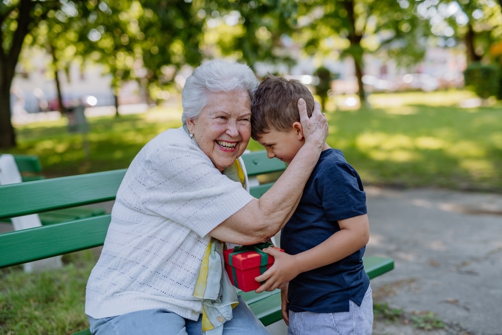 Great-grandson giving his great-grandma a birthday gift