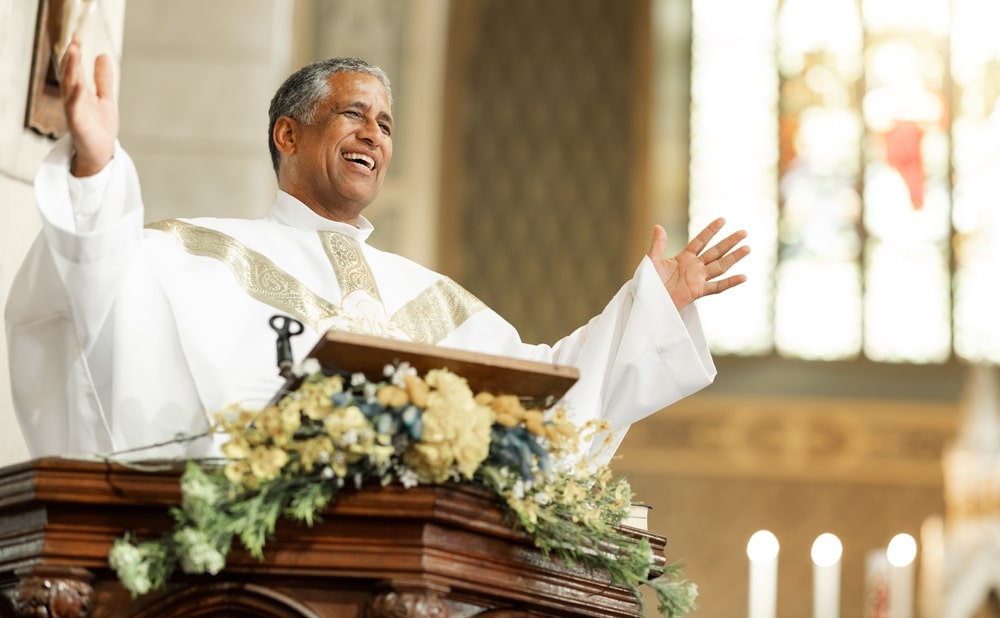 Man giving a sermon at the front of a church