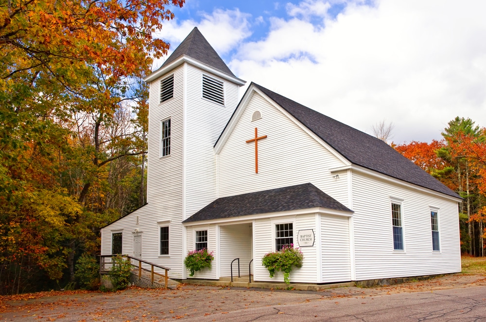 Exterior of a rural church in a wooded area