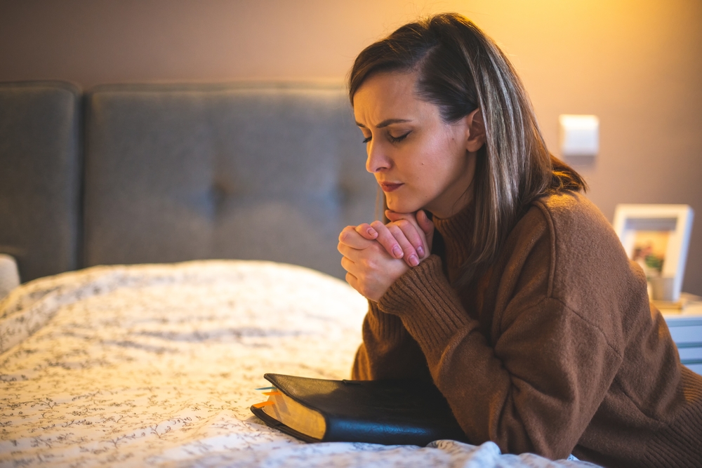 Woman reciting an AA night prayer before bed