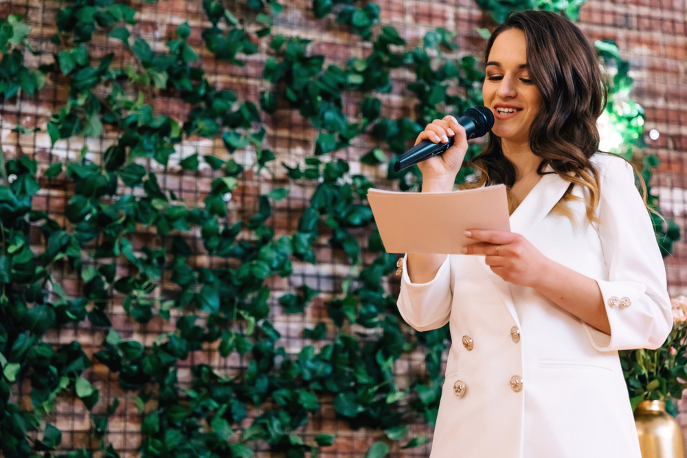 Woman hosting a special event and giving a speech to the crowd