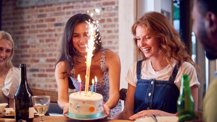 Group of friends celebrating their female friend's birthday