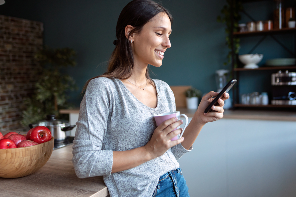 Woman reading a flirty "Have a good day" text message