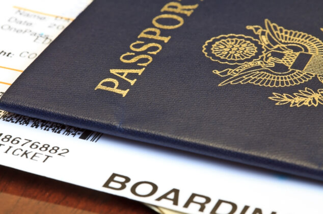 Close-up of a person's passport and boarding pass for a trip abroad