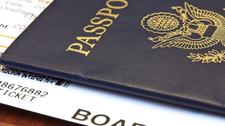 Close-up of a person's passport and boarding pass for a trip abroad