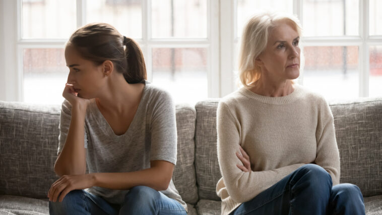 A woman and her estranged daughter sitting next to each other quarreling