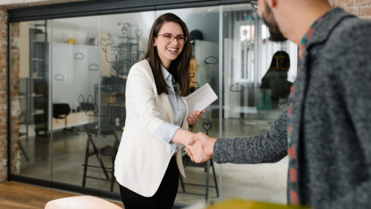 Woman and man shaking hands in the office