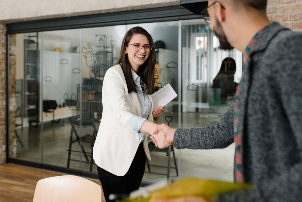 Woman and man shaking hands in the office